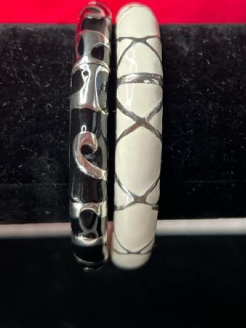 Set of two clamp bangle bracelets. Black and white with Silver tones